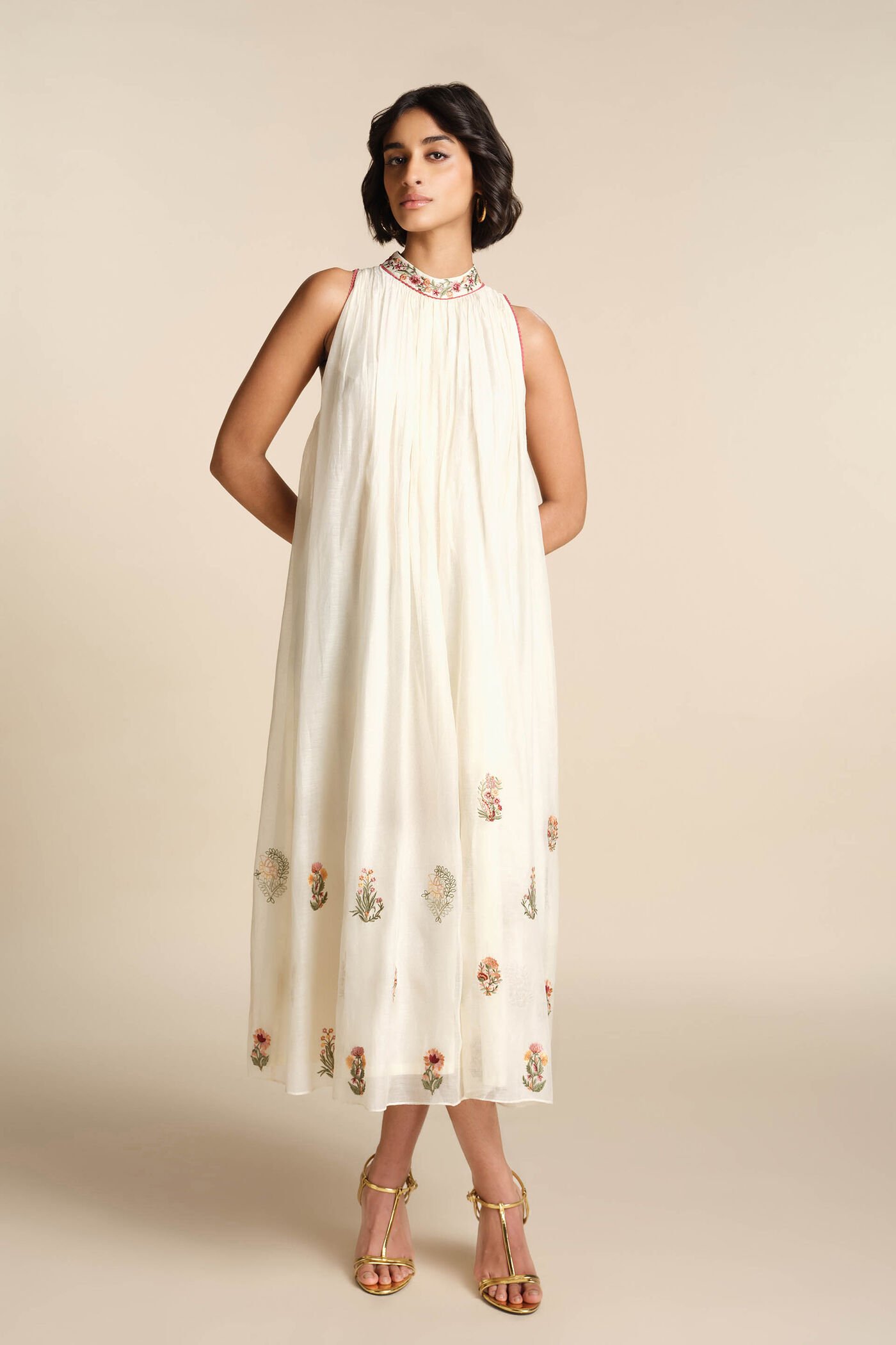 Ivory sleeveless embroidered midi dress with floral motifs and high neckline, elegant festive wear for women