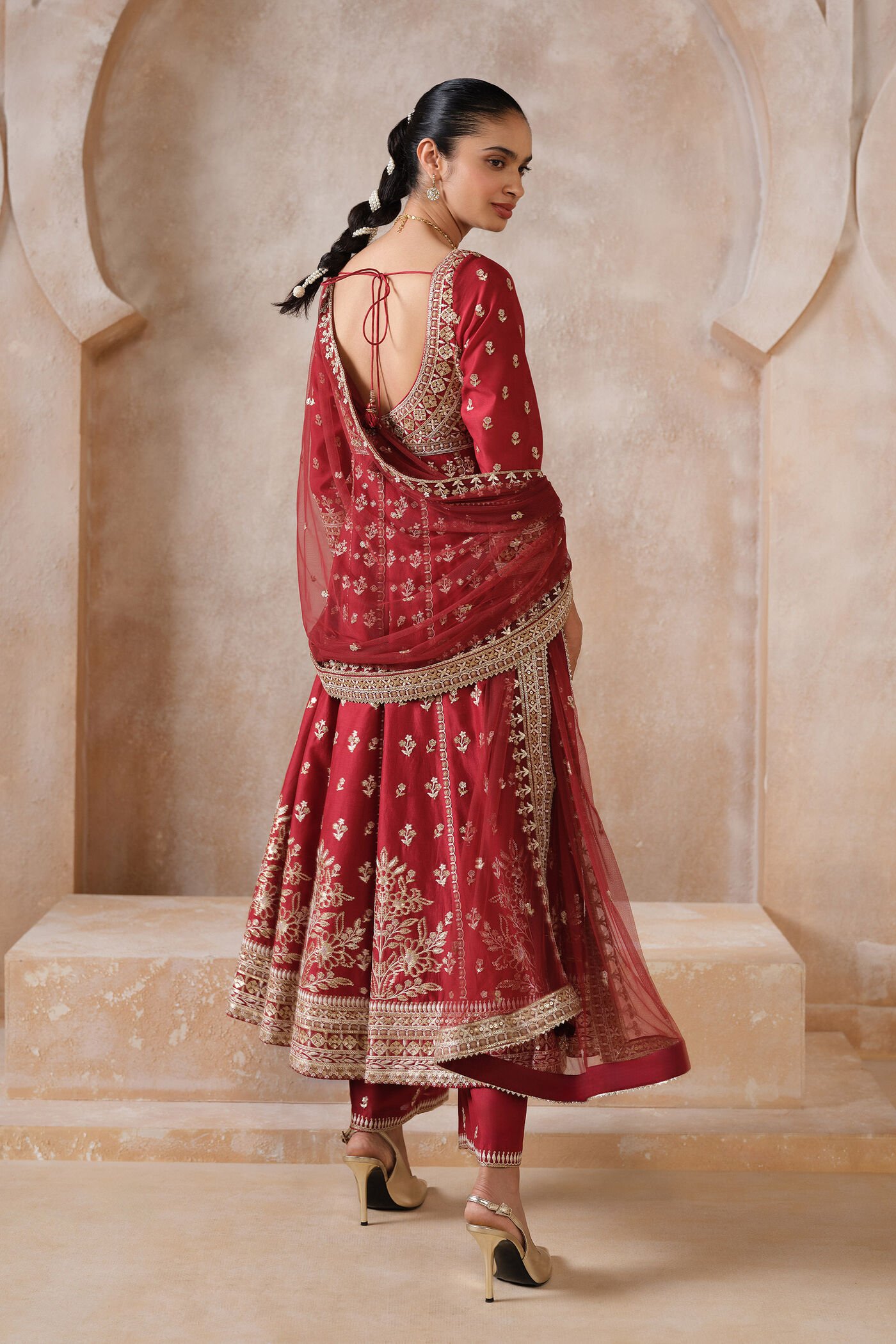 Traditional red Anarkali suit with heavy gold embroidery and matching dupatta for bridal and festive wear.